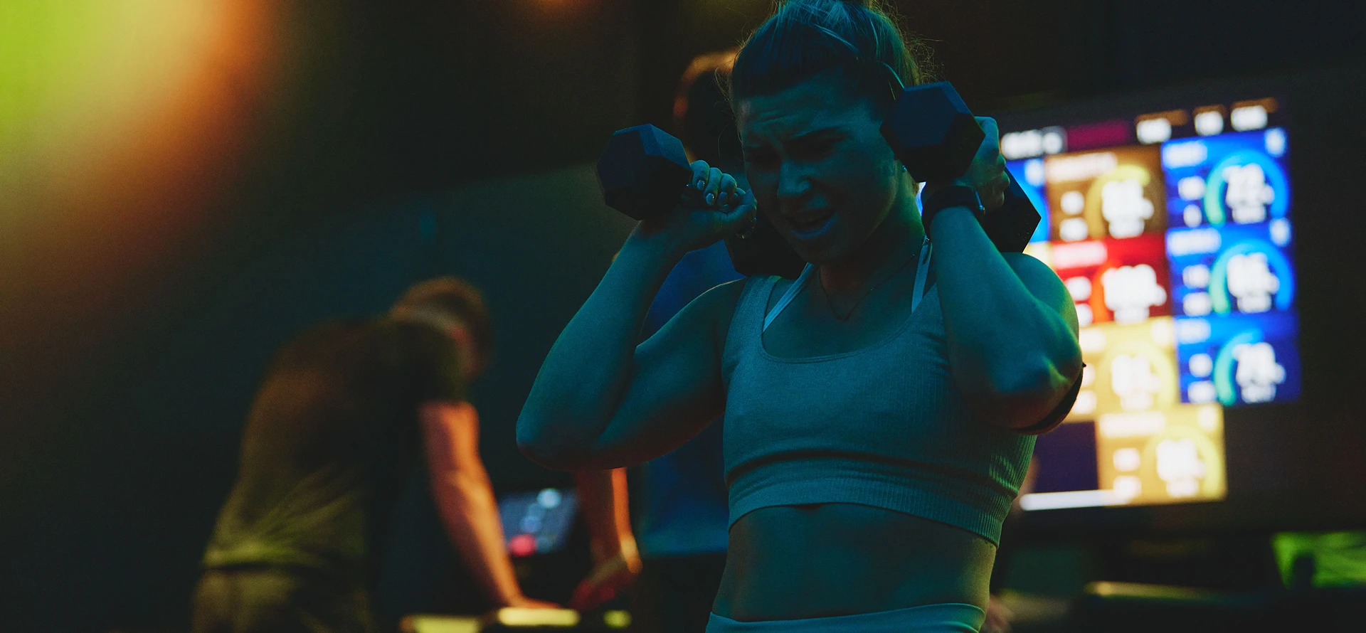 Woman at TRIB3 lifting weight in the Resistance zone.