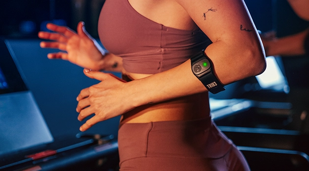 Woman on treadmill wearing the SWEAT Band